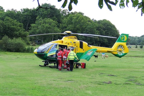 SCAS air ambulance crew loading into the helicopter  in a large field