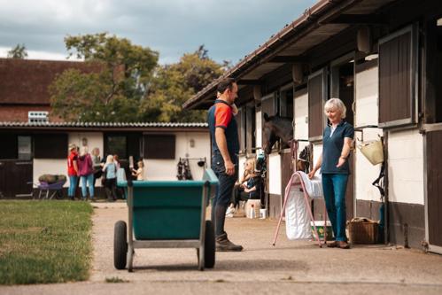 A busy yard with people chatting in groups